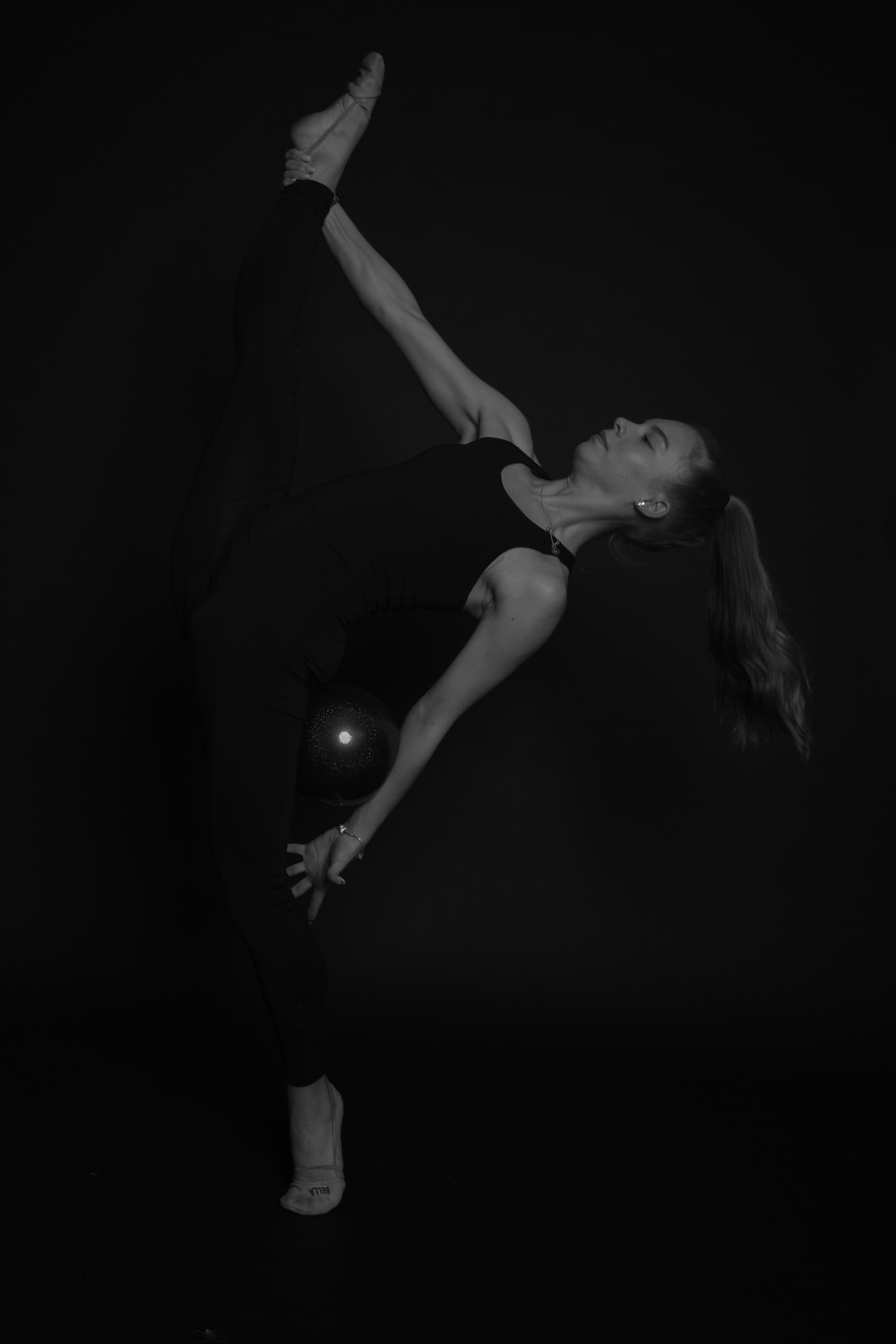 A dancer in a dramatic pose against a dark background