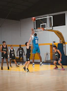Basketball players jumping for a rebound during a game.