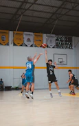 Basketball players jumping for the ball during a game.
