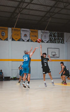 Basketball players jumping for the ball during a game.