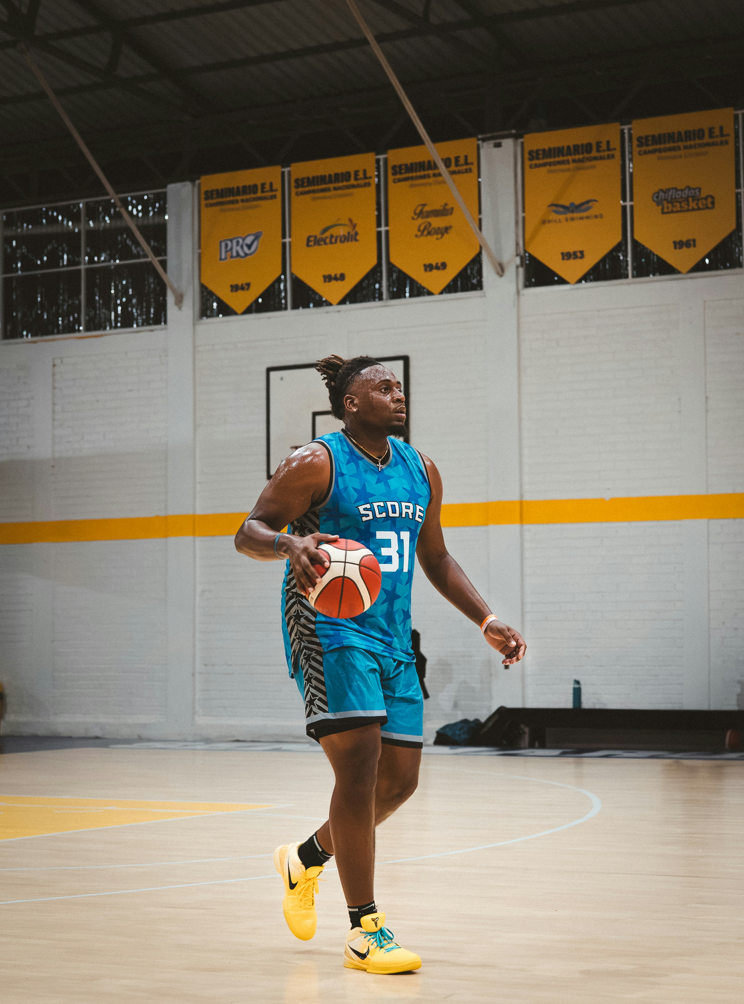 Basketball player dribbling ball on court
