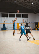 Three basketball players on a court during a game.