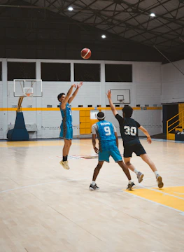 Three basketball players on a court during a game.