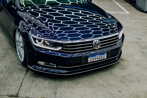 Dark blue car with hexagonal pattern on hood.