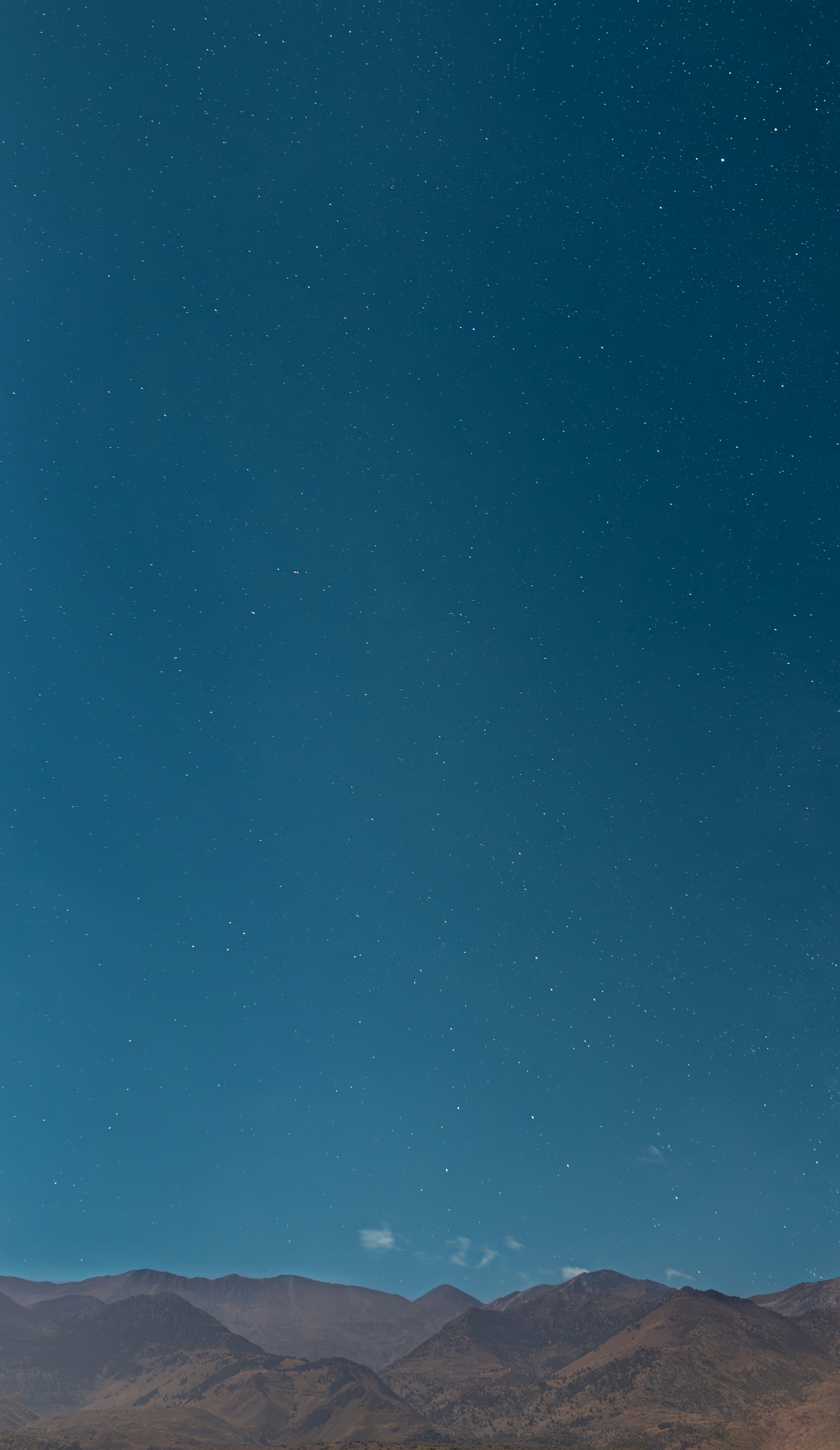 Starry night sky over mountains