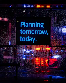 Neon sign reads "planning tomorrow, today."