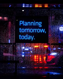 Neon sign reads "planning tomorrow, today."