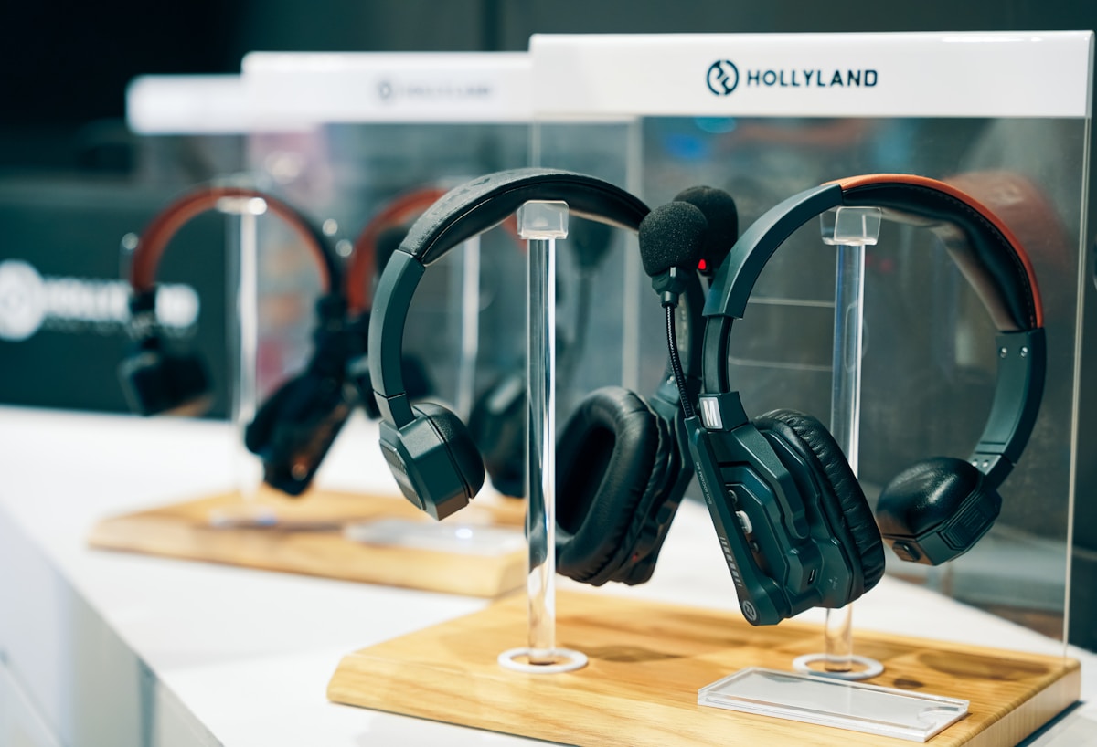 Several black headphones displayed on stands.