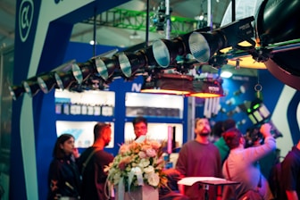 People gather under stage lights at an event