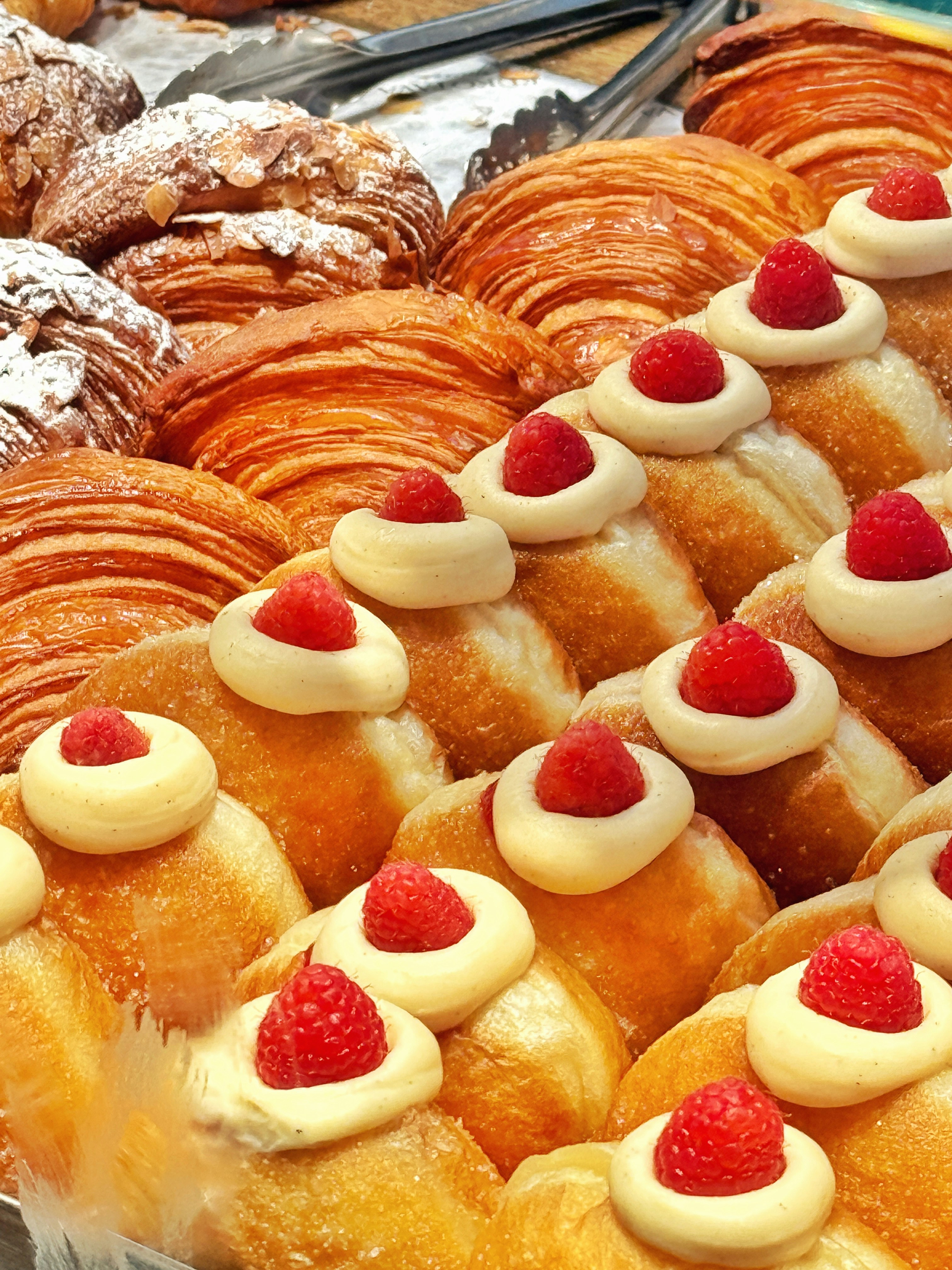 Assortment of fresh pastries with raspberries and without raspberries