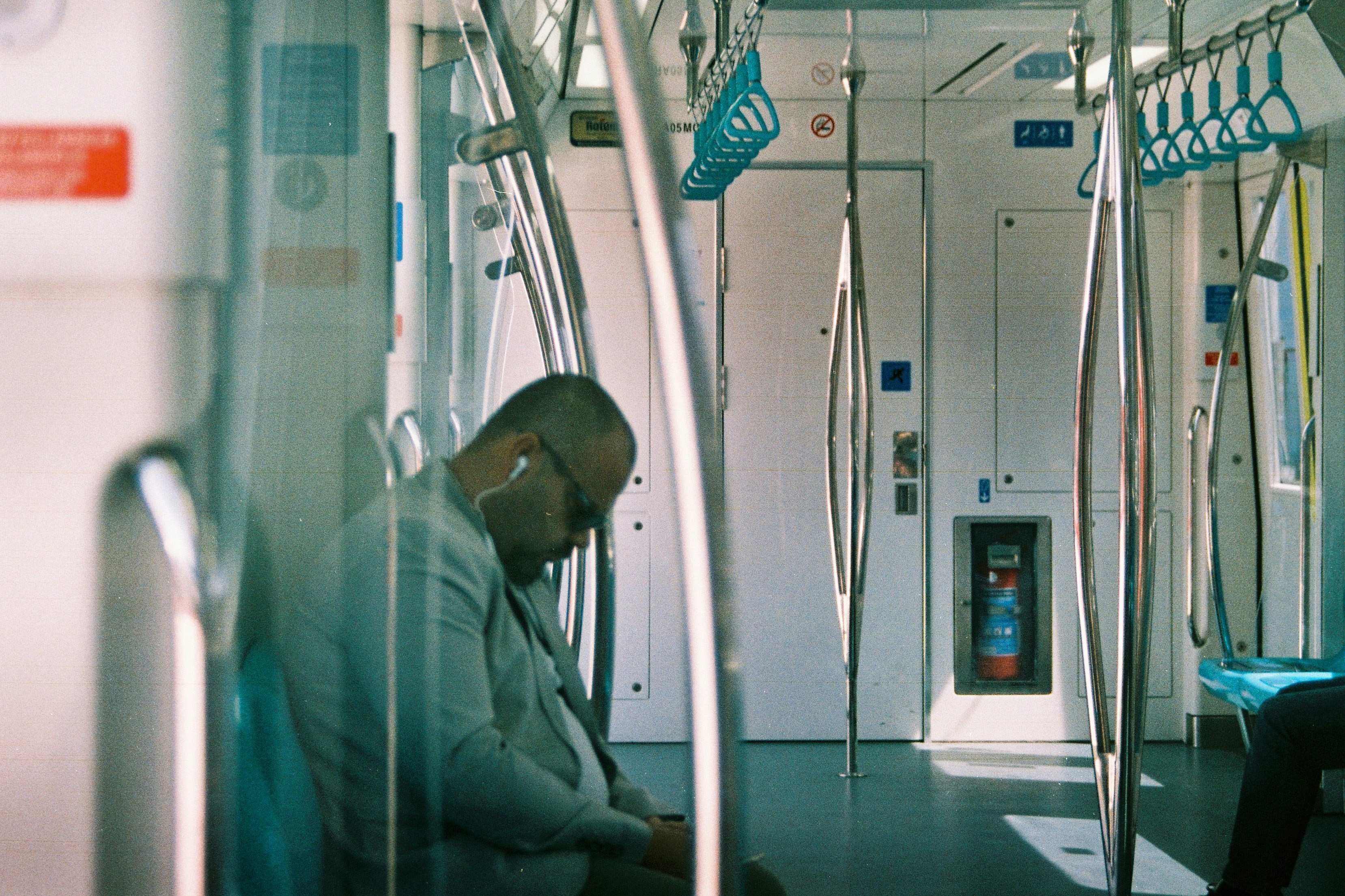 Man sleeping on a train during commute