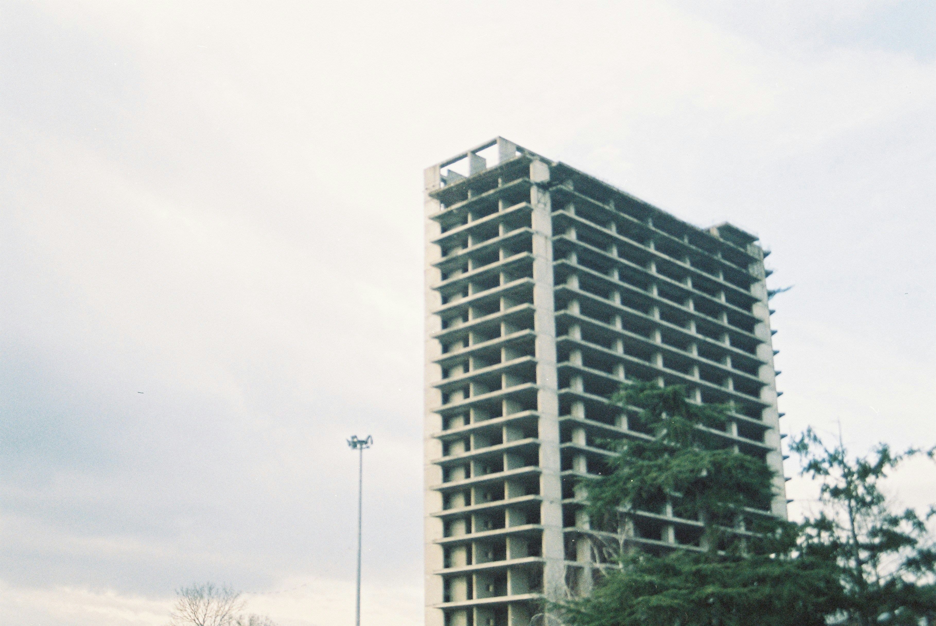 Unfinished concrete skyscraper against a cloudy sky