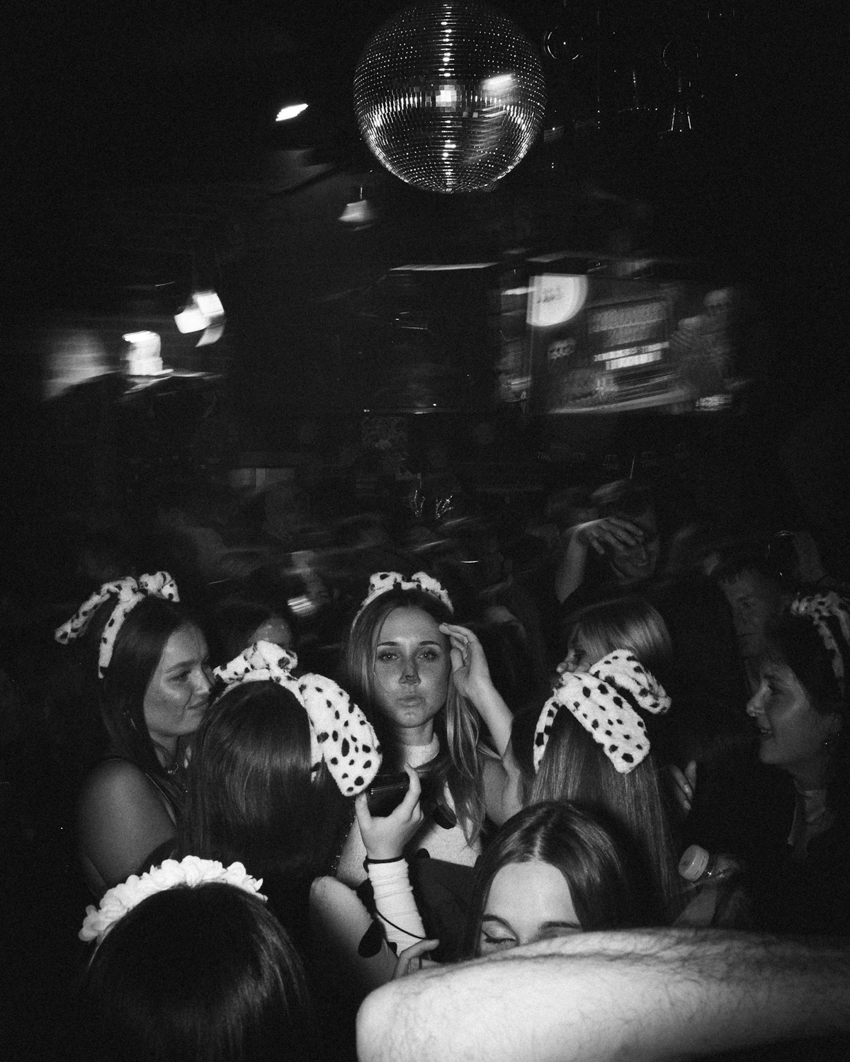 Women dancing beneath a disco ball