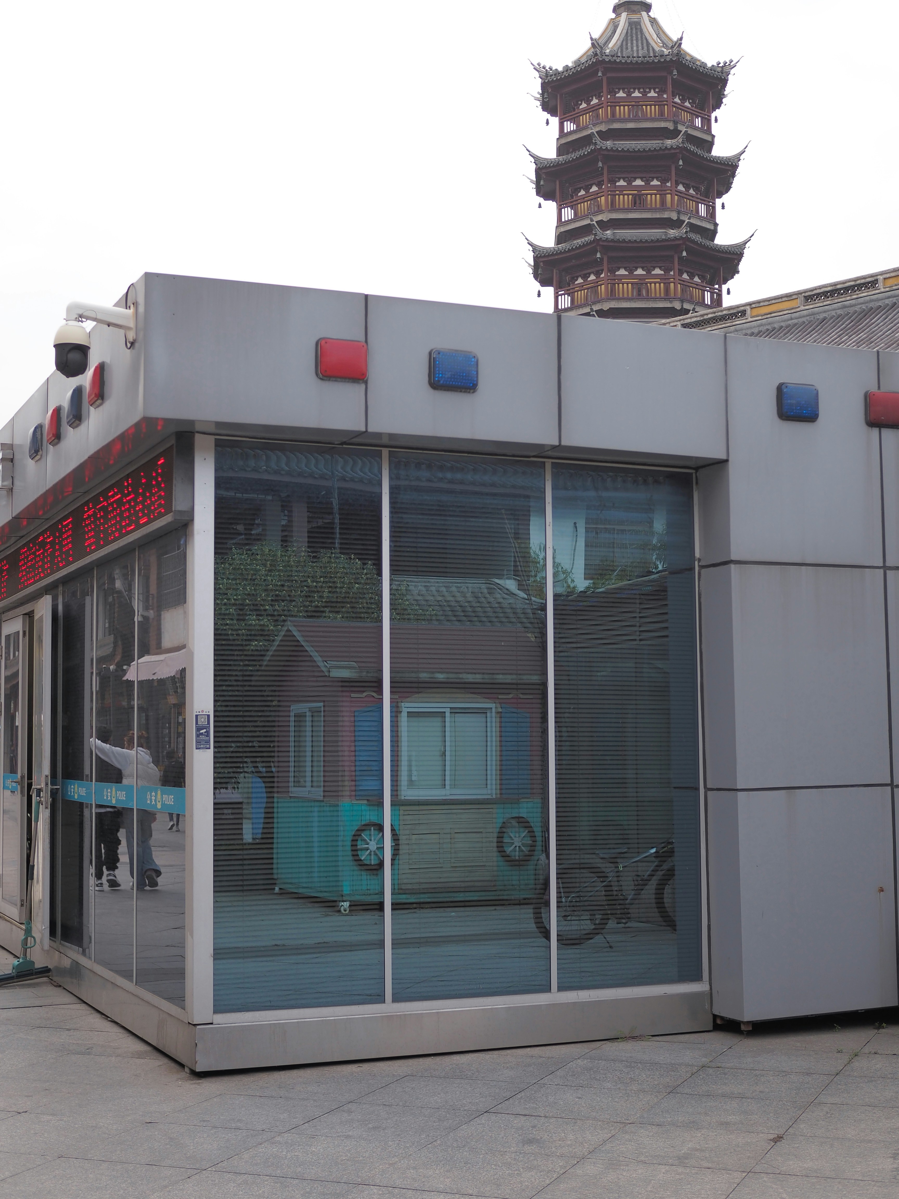 Modern security booth with traditional pagoda in background