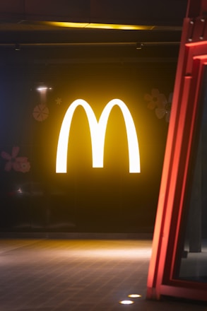 Glowing mcdonald's logo on a dark background