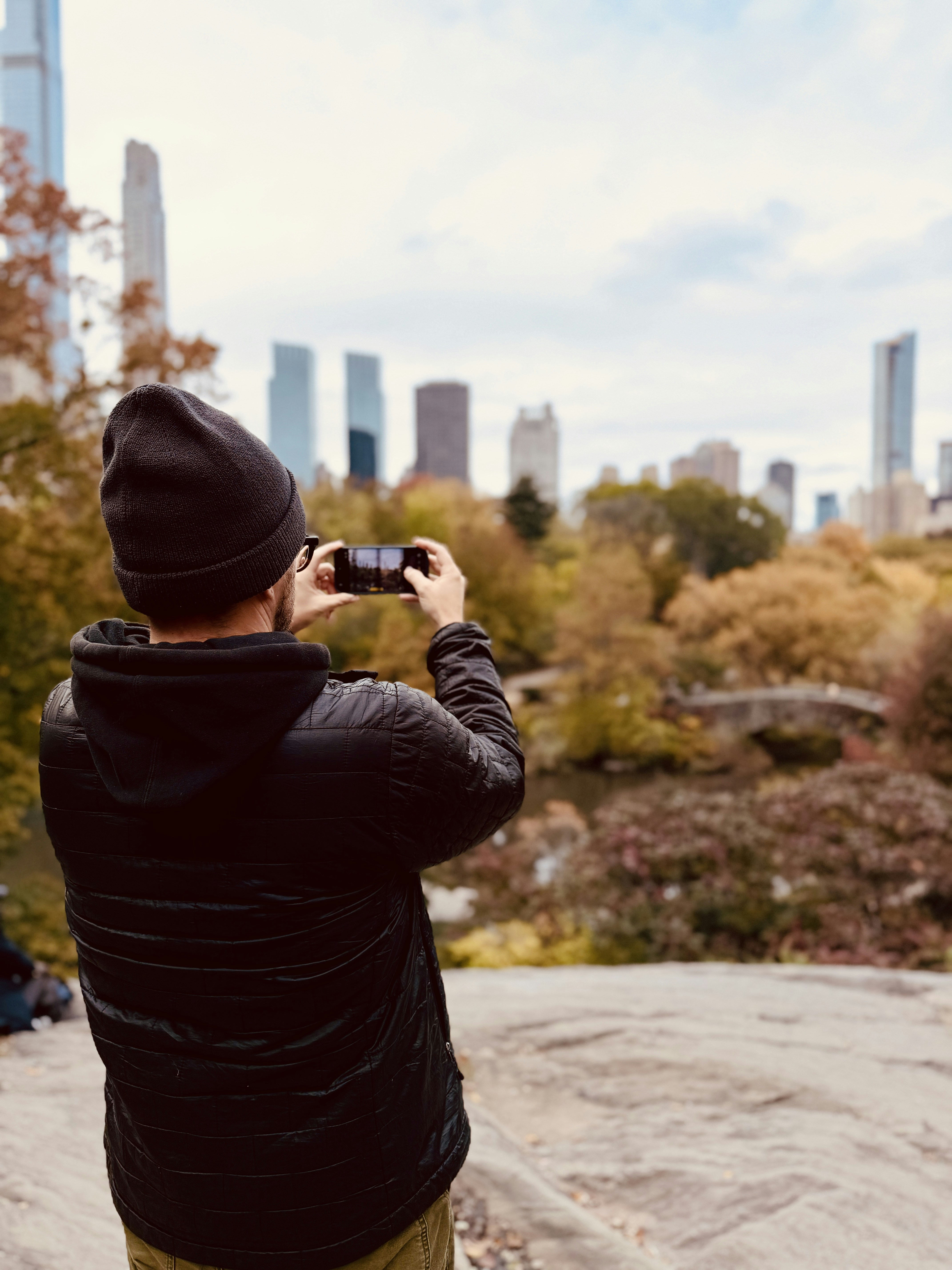 Man taking a picture of city skyline with phone