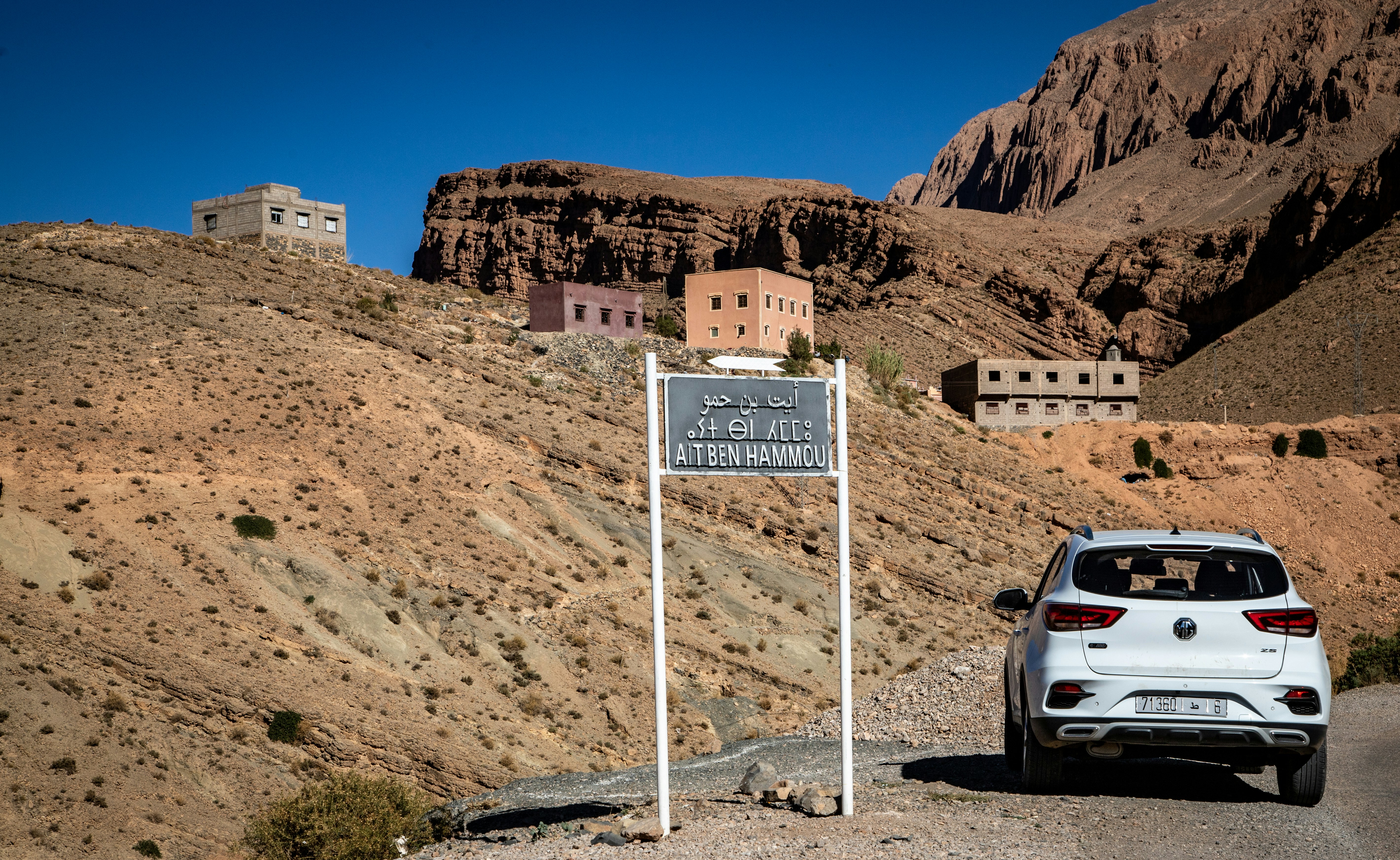 Car passing village sign
