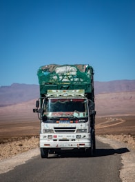 A loaded truck drives on a desert road