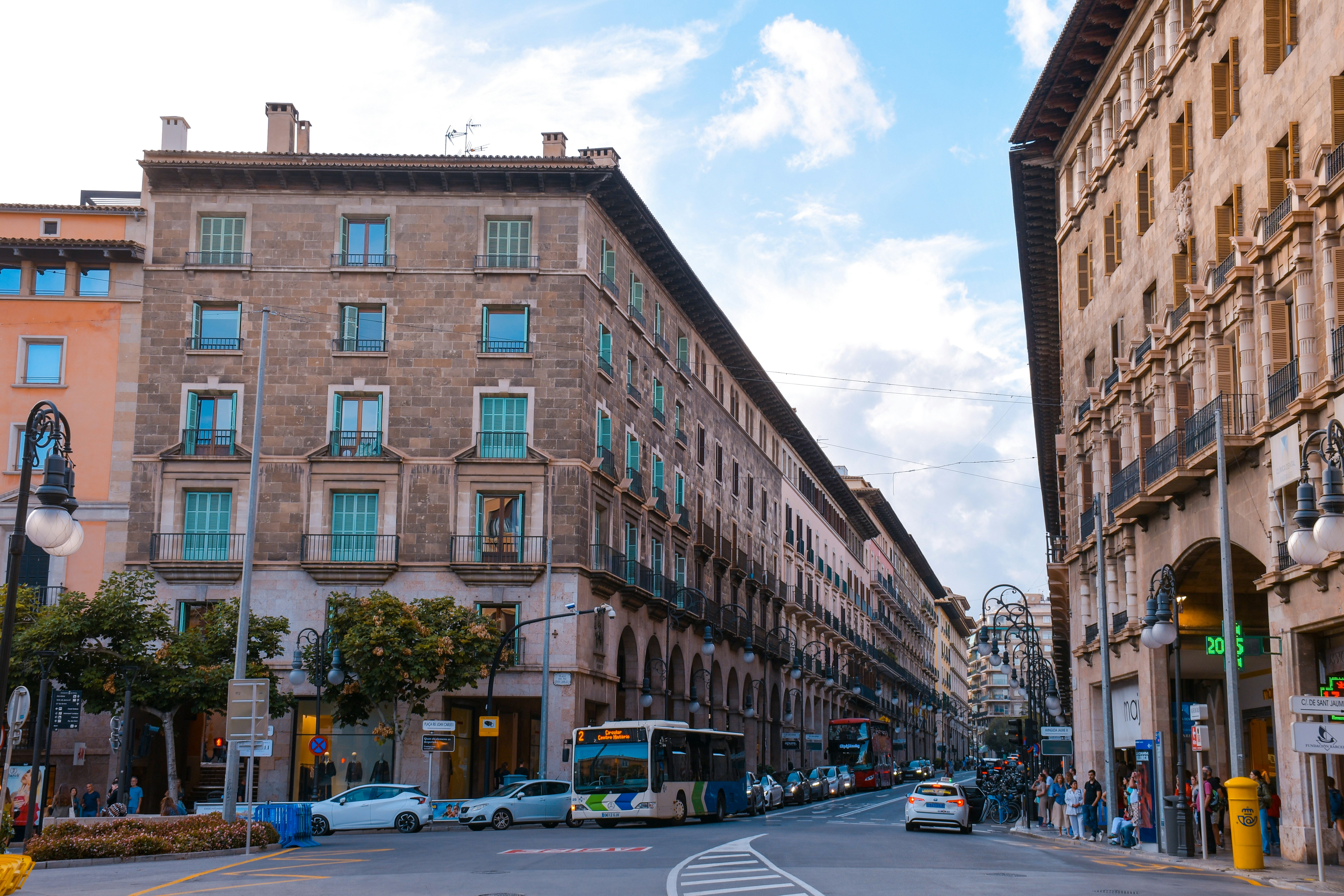 Street view of historic buildings with a bus.