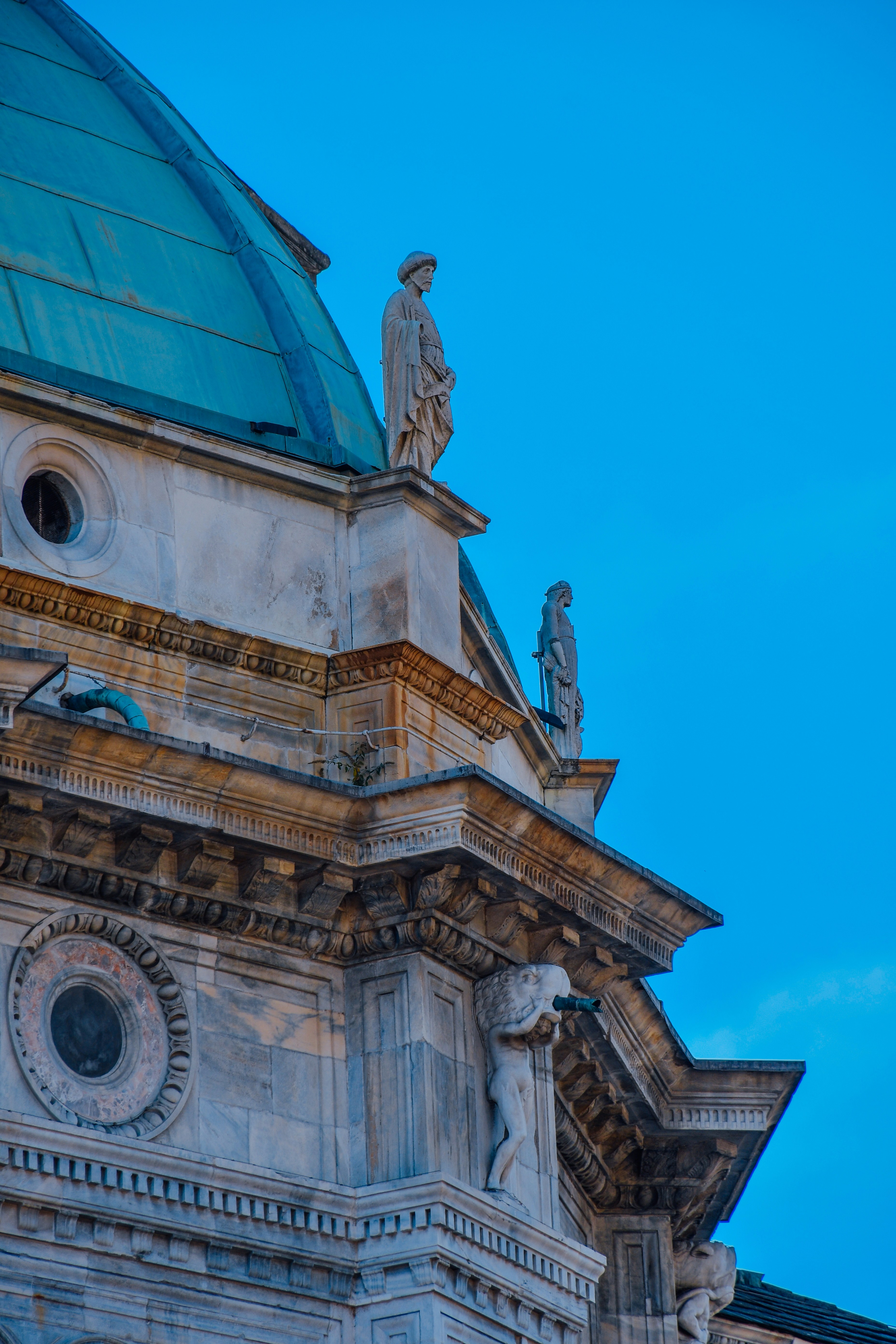 Architectural detail with statues and a dome