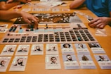 People playing a board game with cards and pieces.