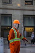 Construction worker in orange jumpsuit and hard hat