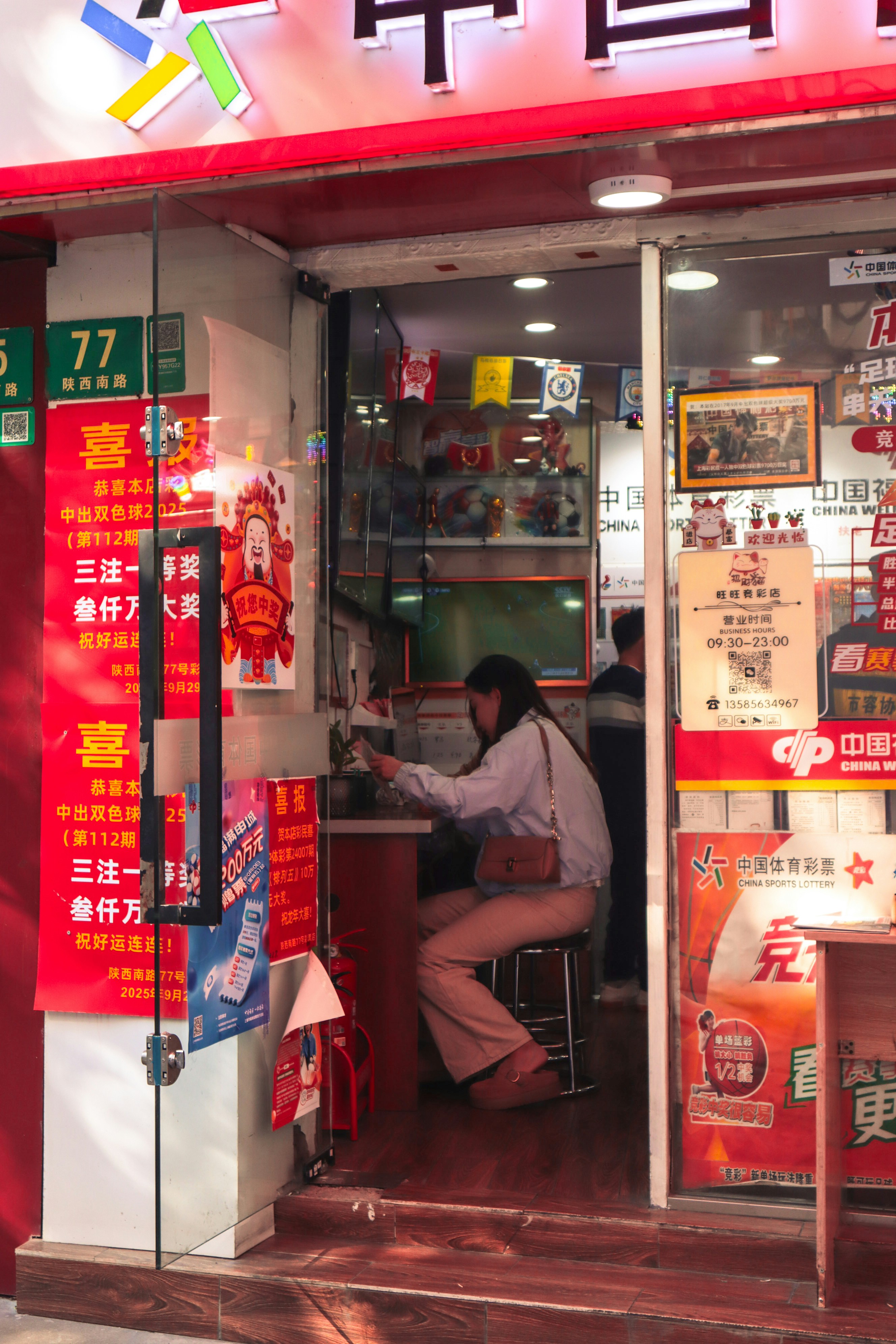 Woman working at a small store counter