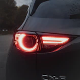 Close up of a red car taillight at dusk