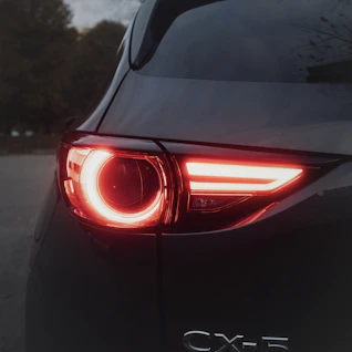 Close up of a red car taillight at dusk