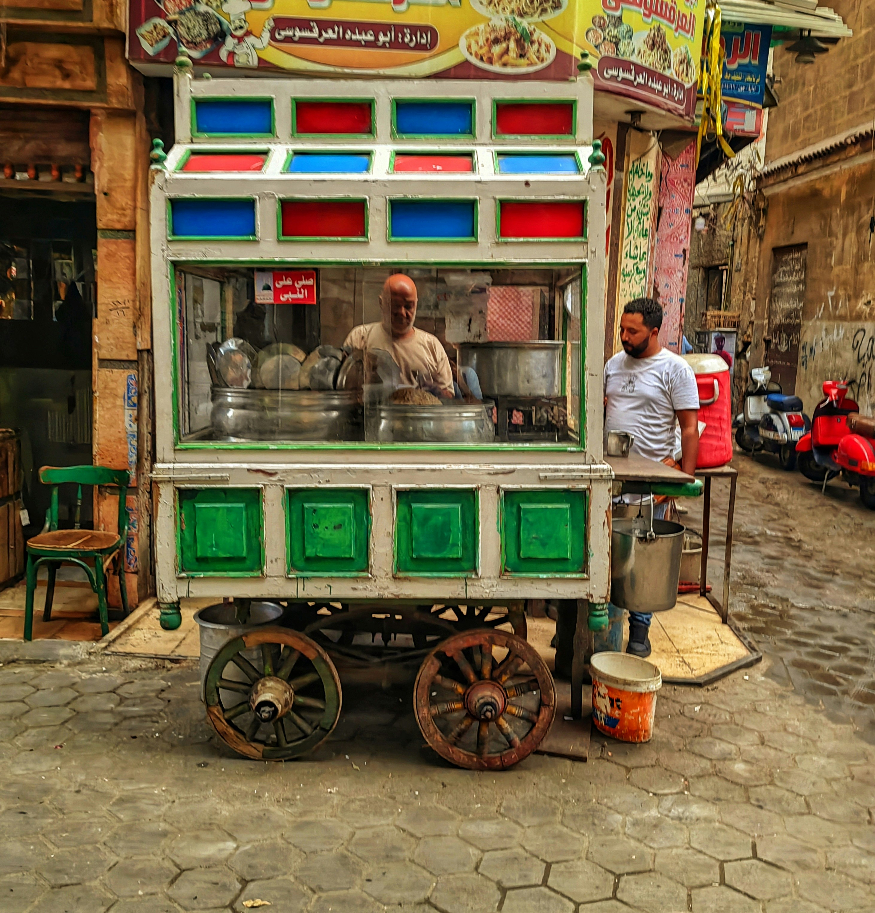 Street food cart with two men working