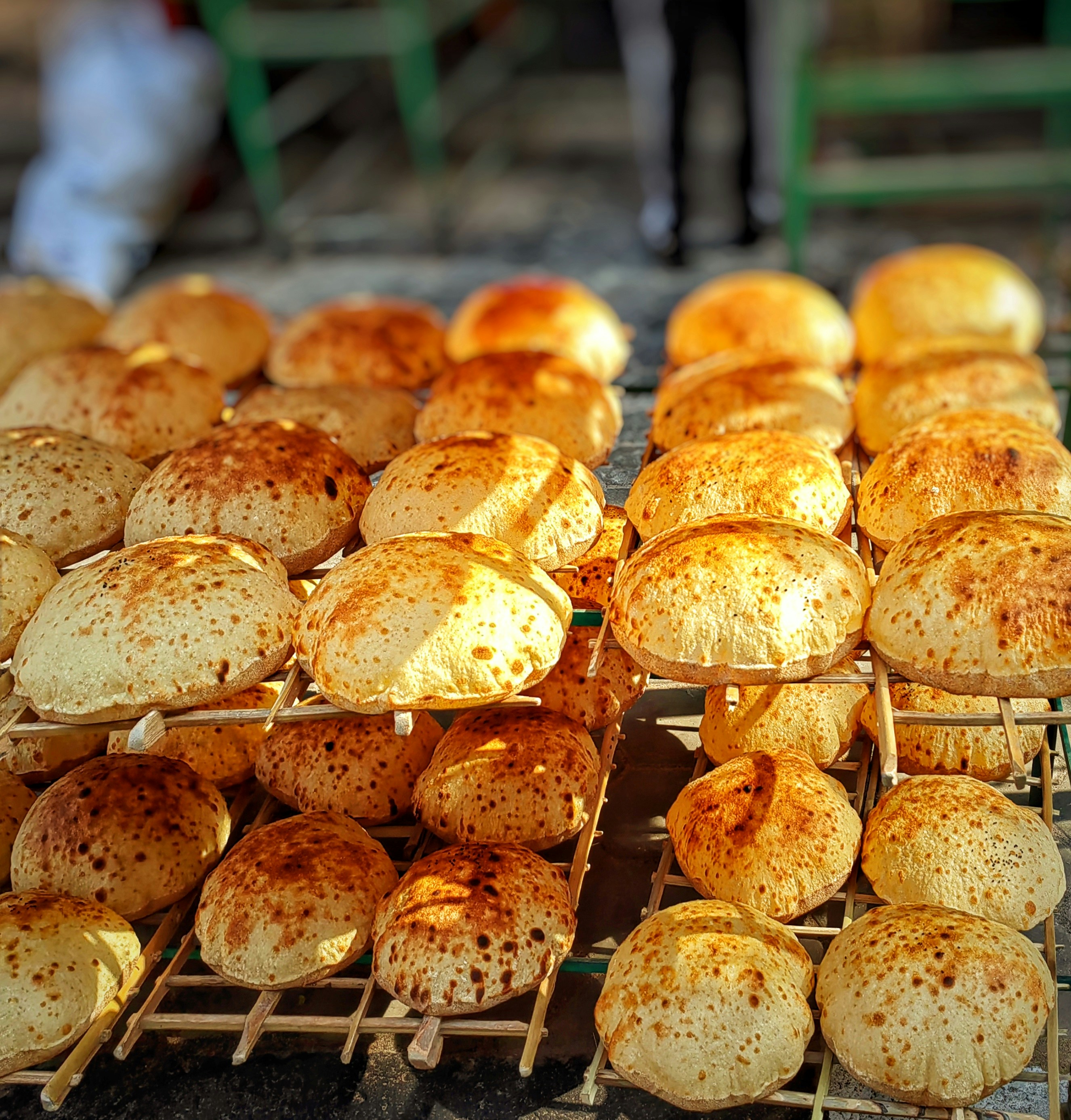 Many small baked goods arranged on racks.