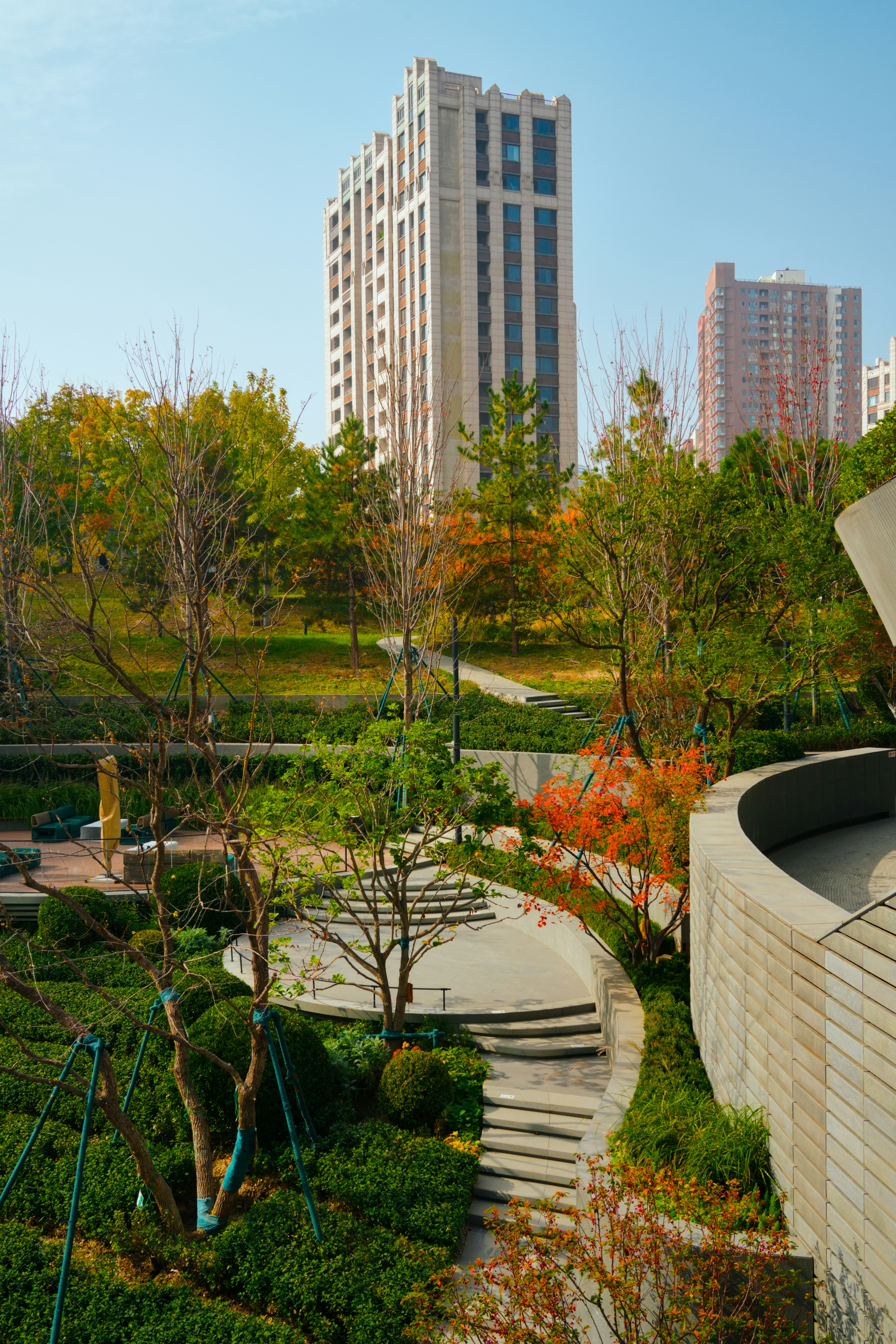 Modern buildings overlook a landscaped park with autumn foliage. photo ...
