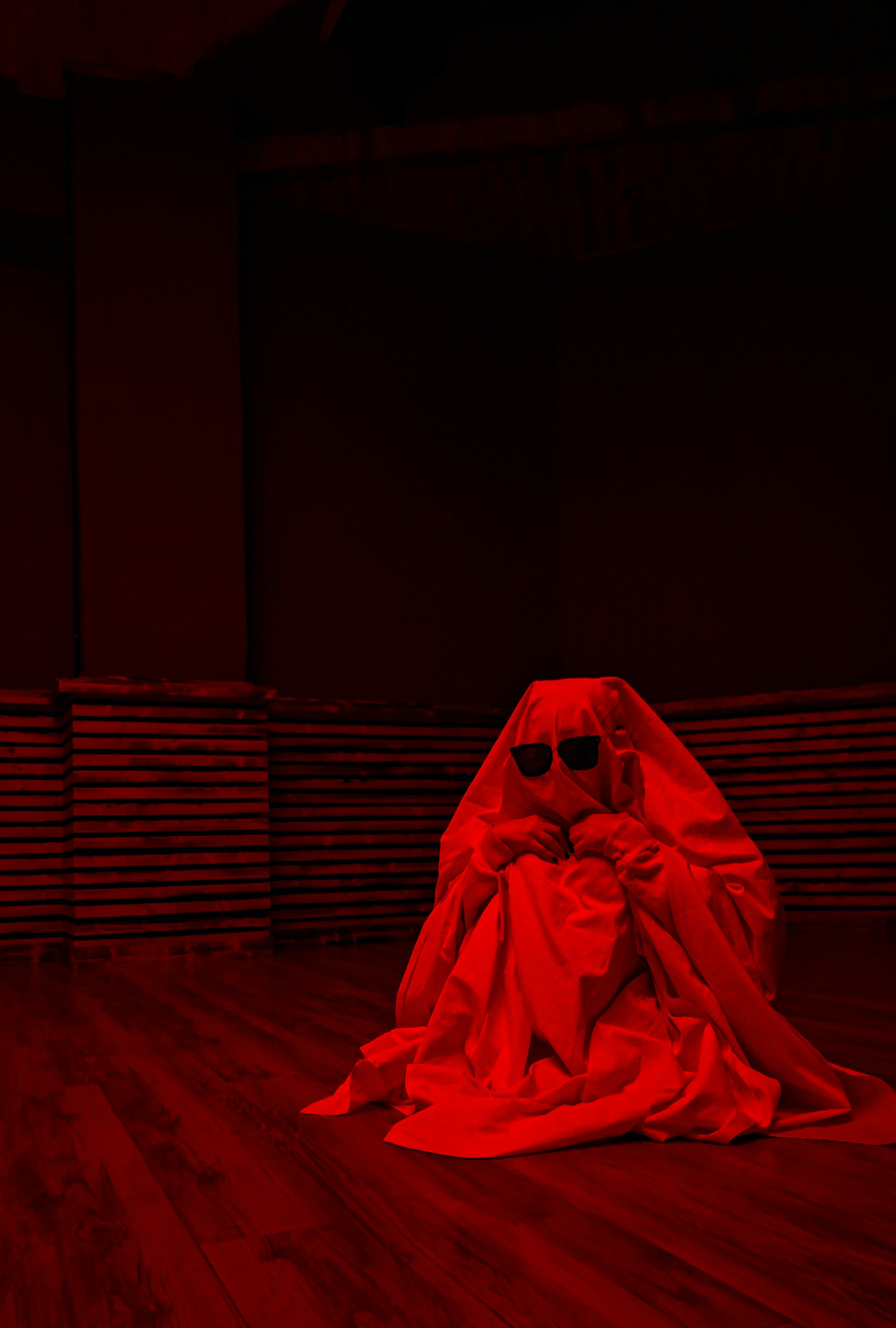 A person in a red sheet wearing sunglasses