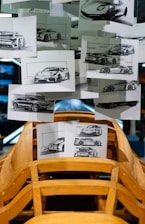 Car design sketches displayed above wooden car frame