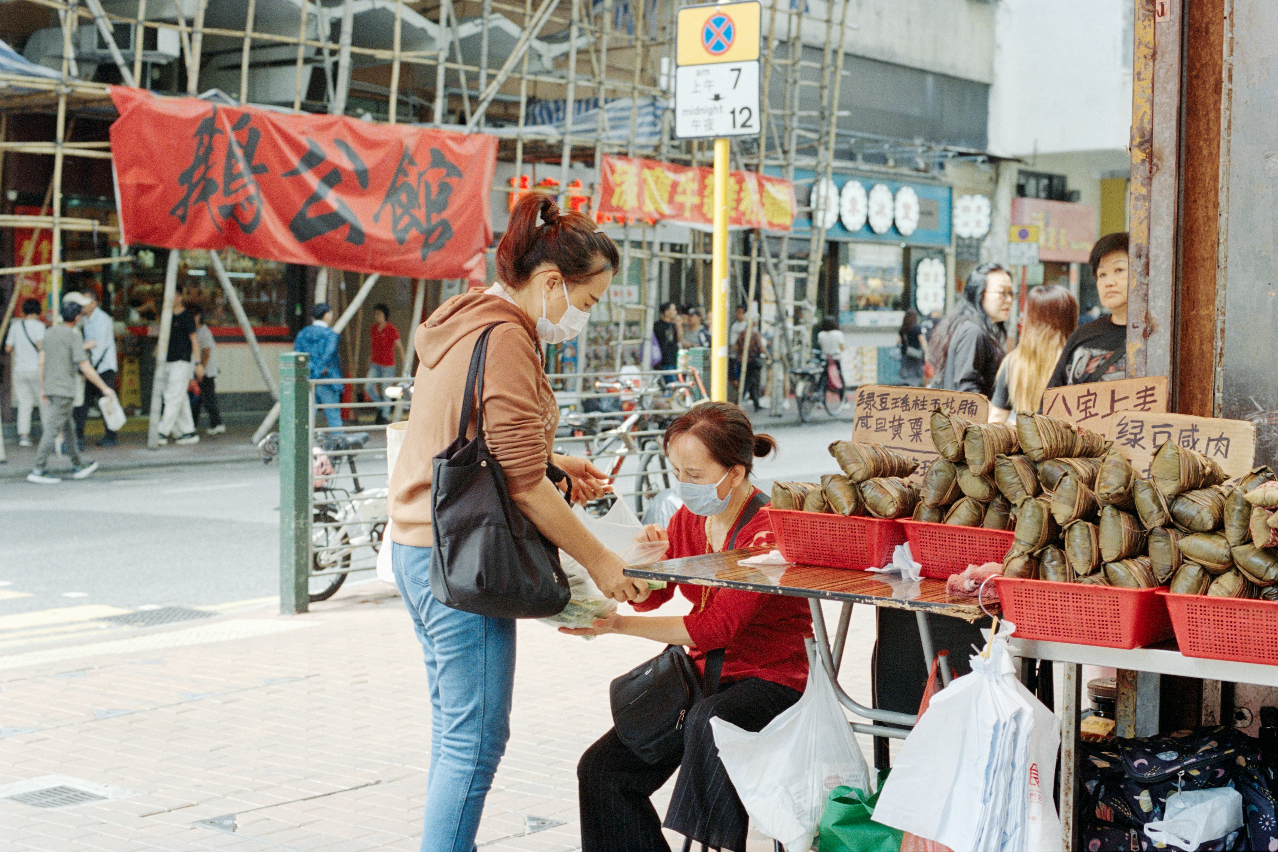 Woman buying food from street vendor