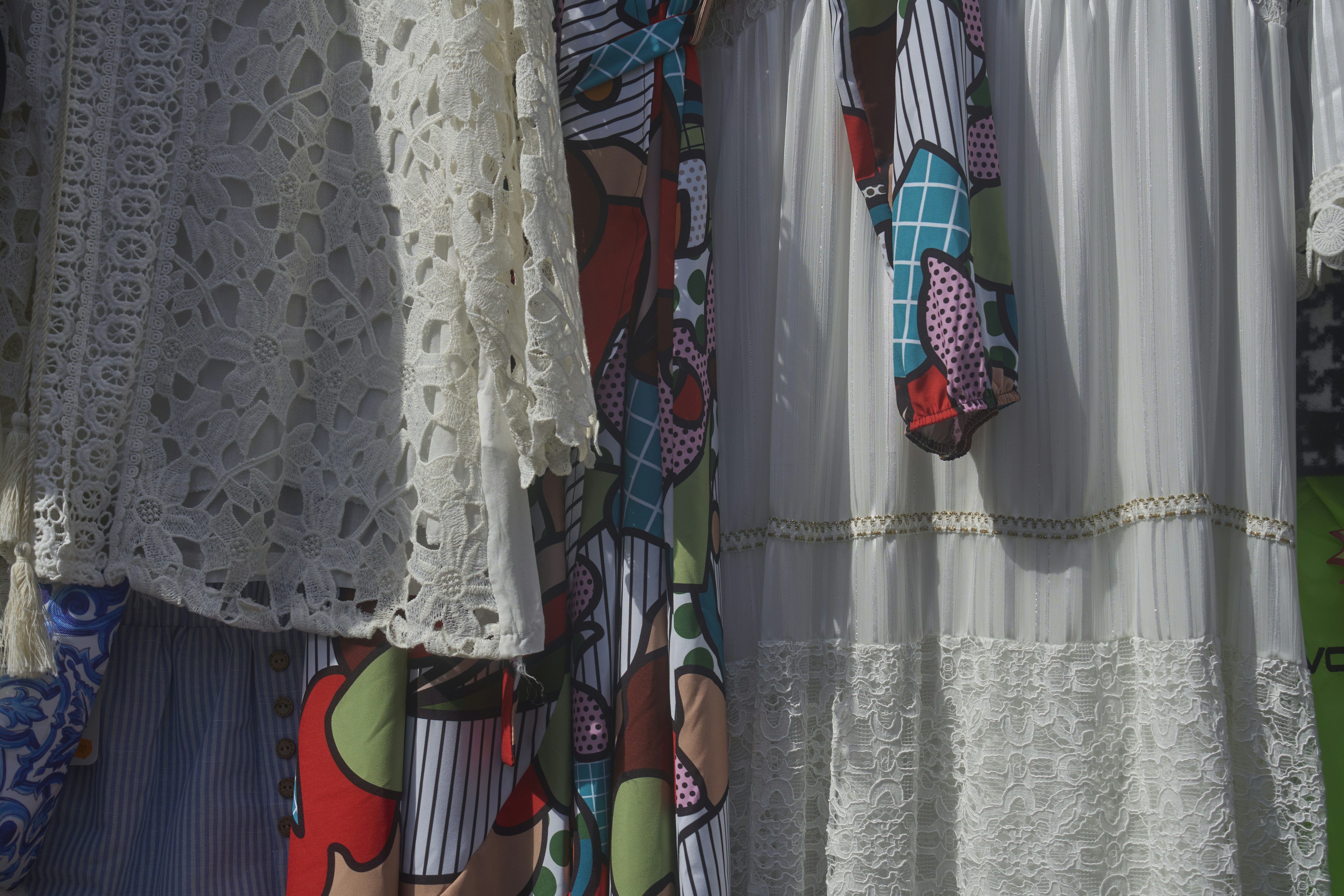 Colorful patterned and white lace clothing items