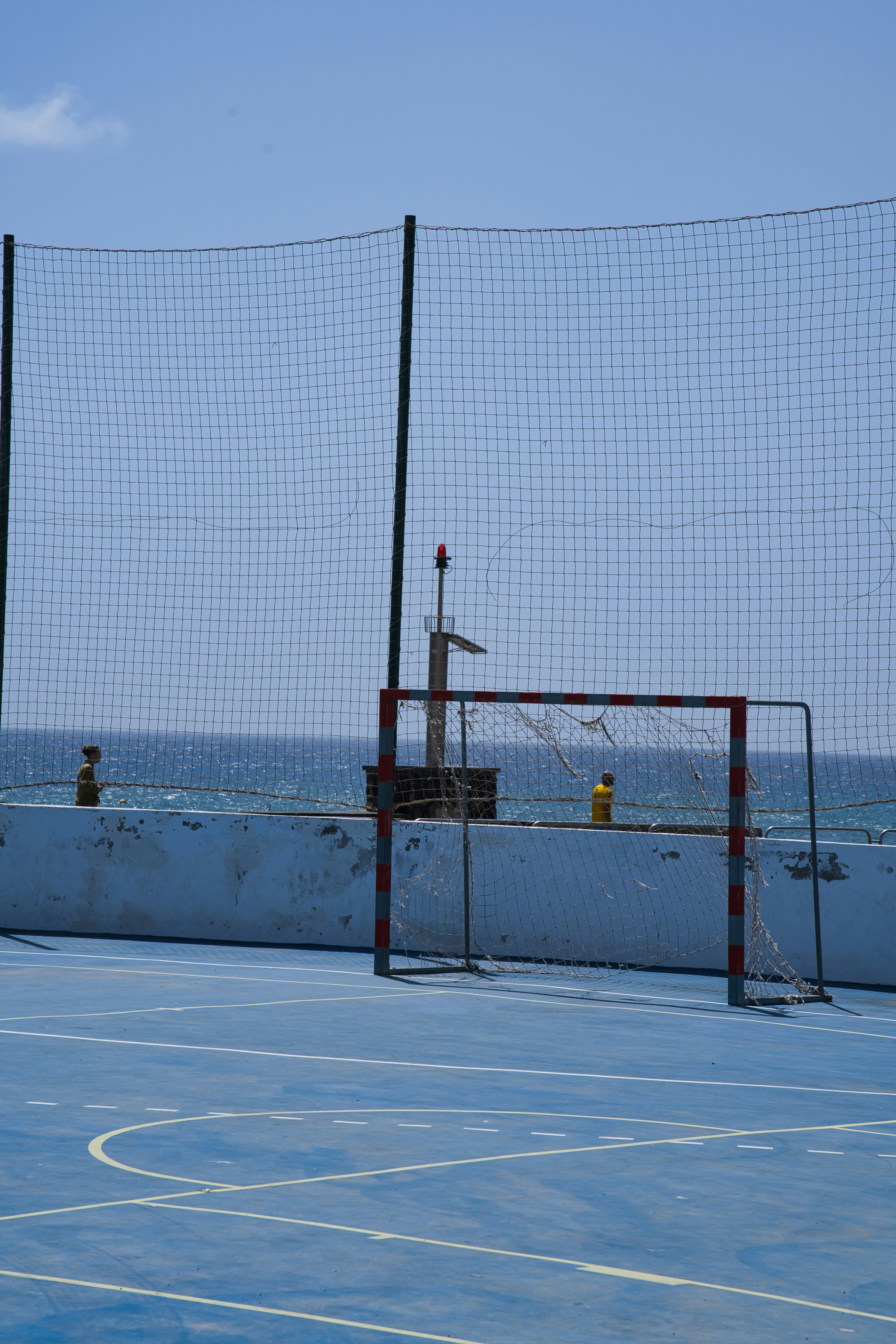 Blue court with soccer goal by the ocean