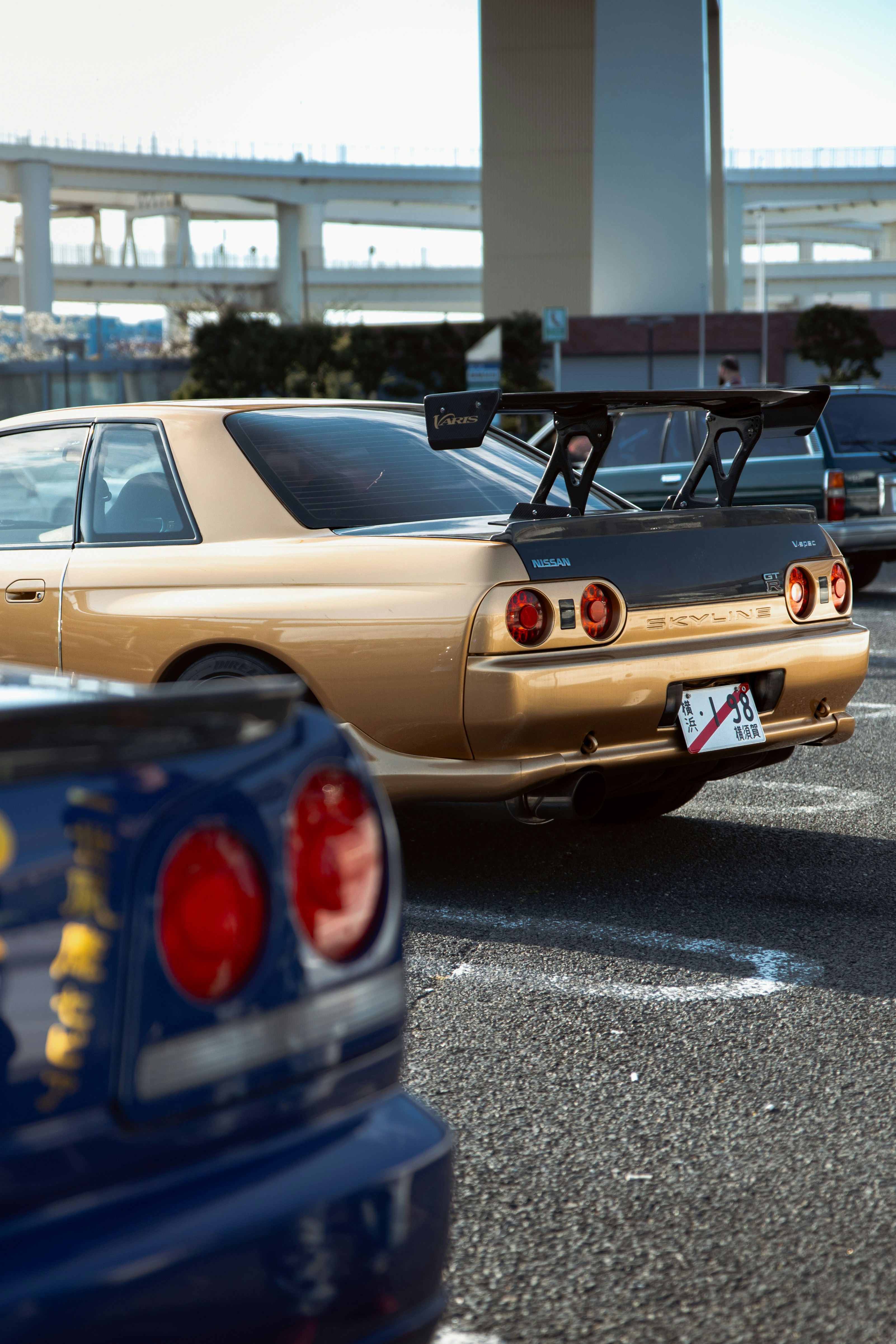 Gold sports car with large rear spoiler