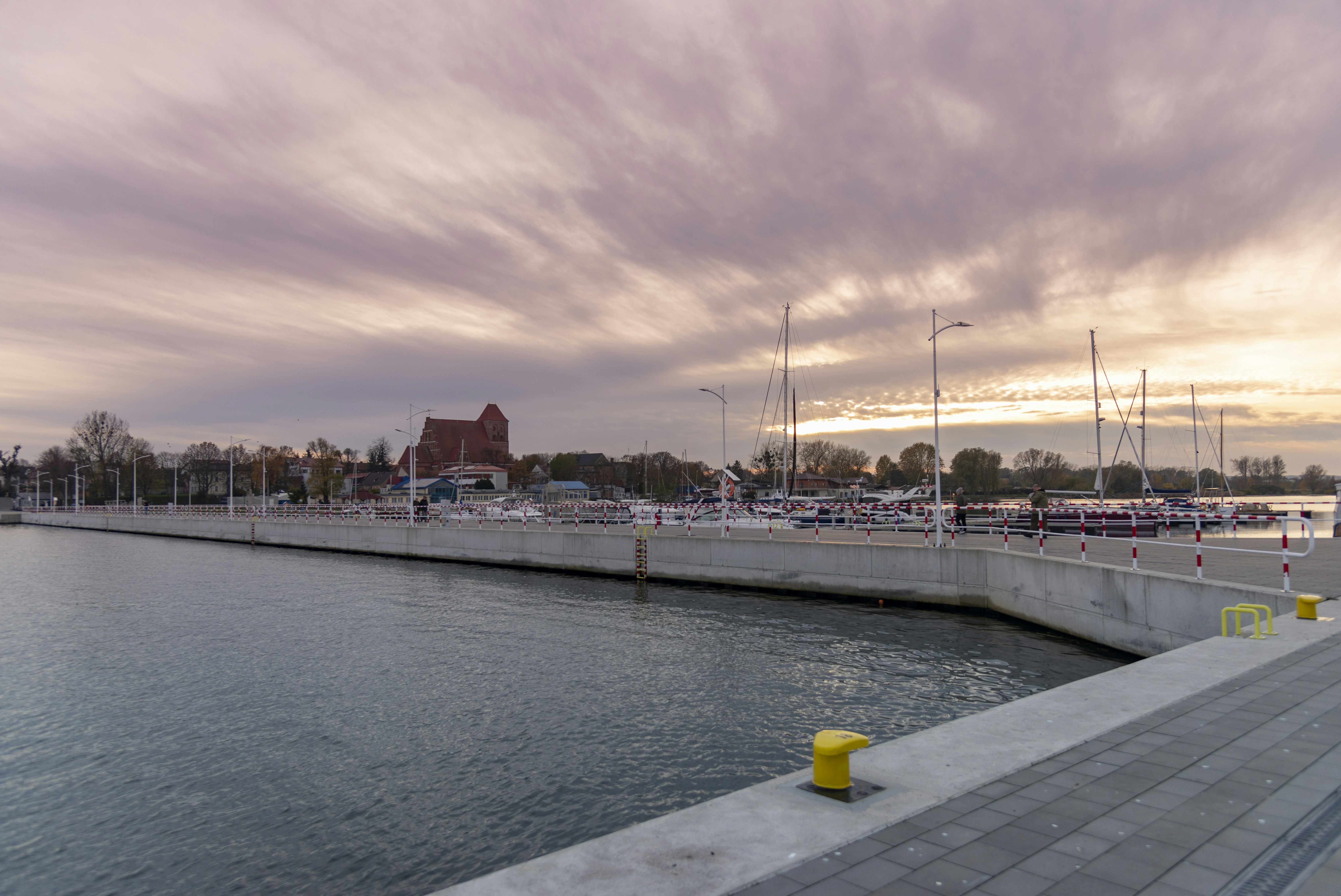 Harbor with boats and a church at sunset