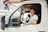 Man driving a white van gives a thumbs up