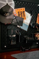Pegboard organizer with hat, map, and tools.
