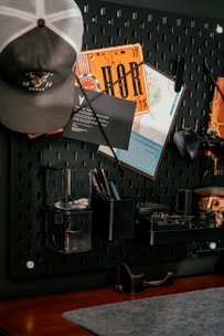 Pegboard organizer with hat, map, and tools.