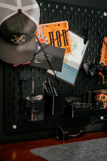 Pegboard organizer with hat, map, and tools.