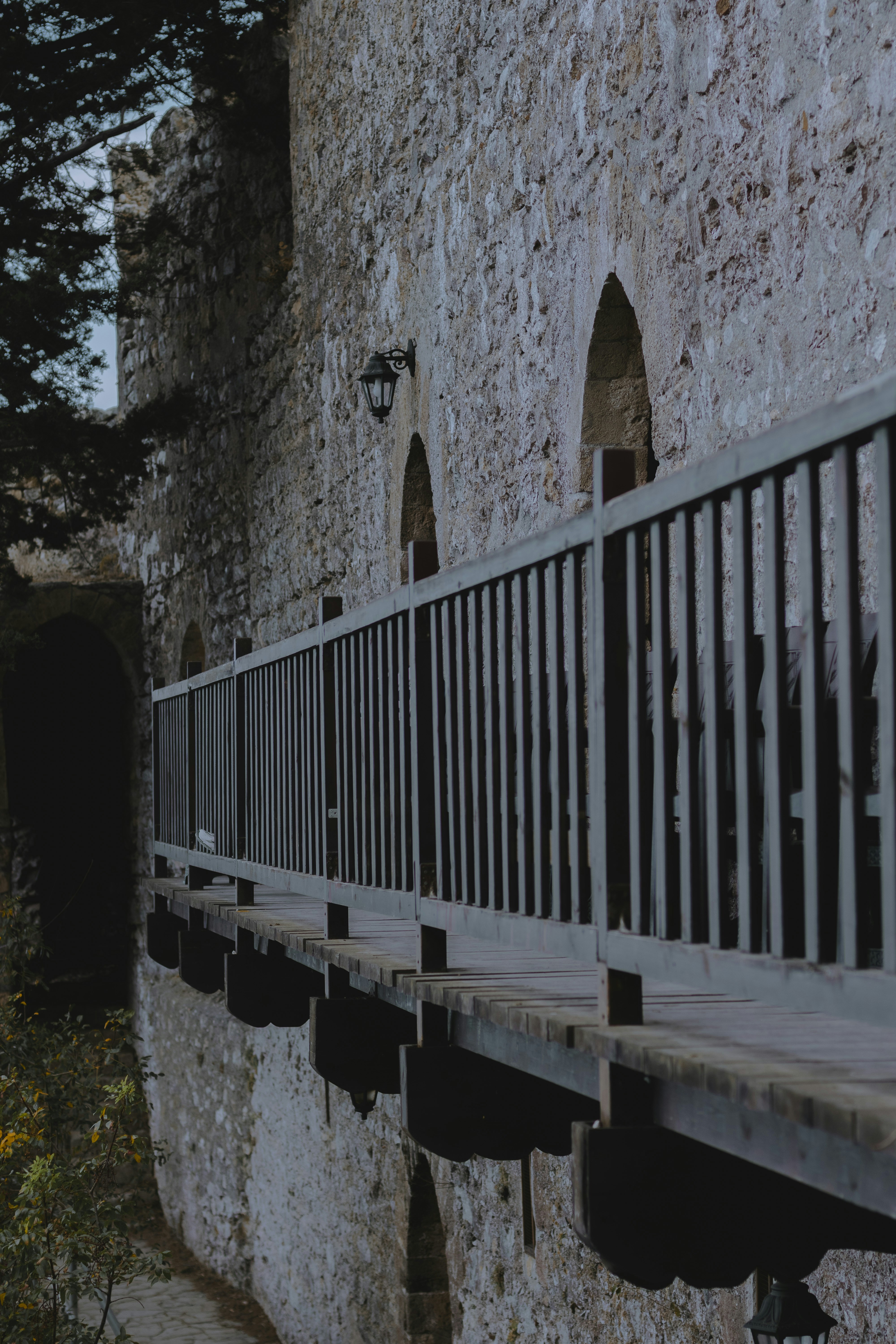Wooden walkway along ancient stone castle wall