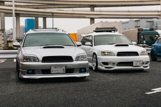 Two subaru legacy wagons parked side-by-side