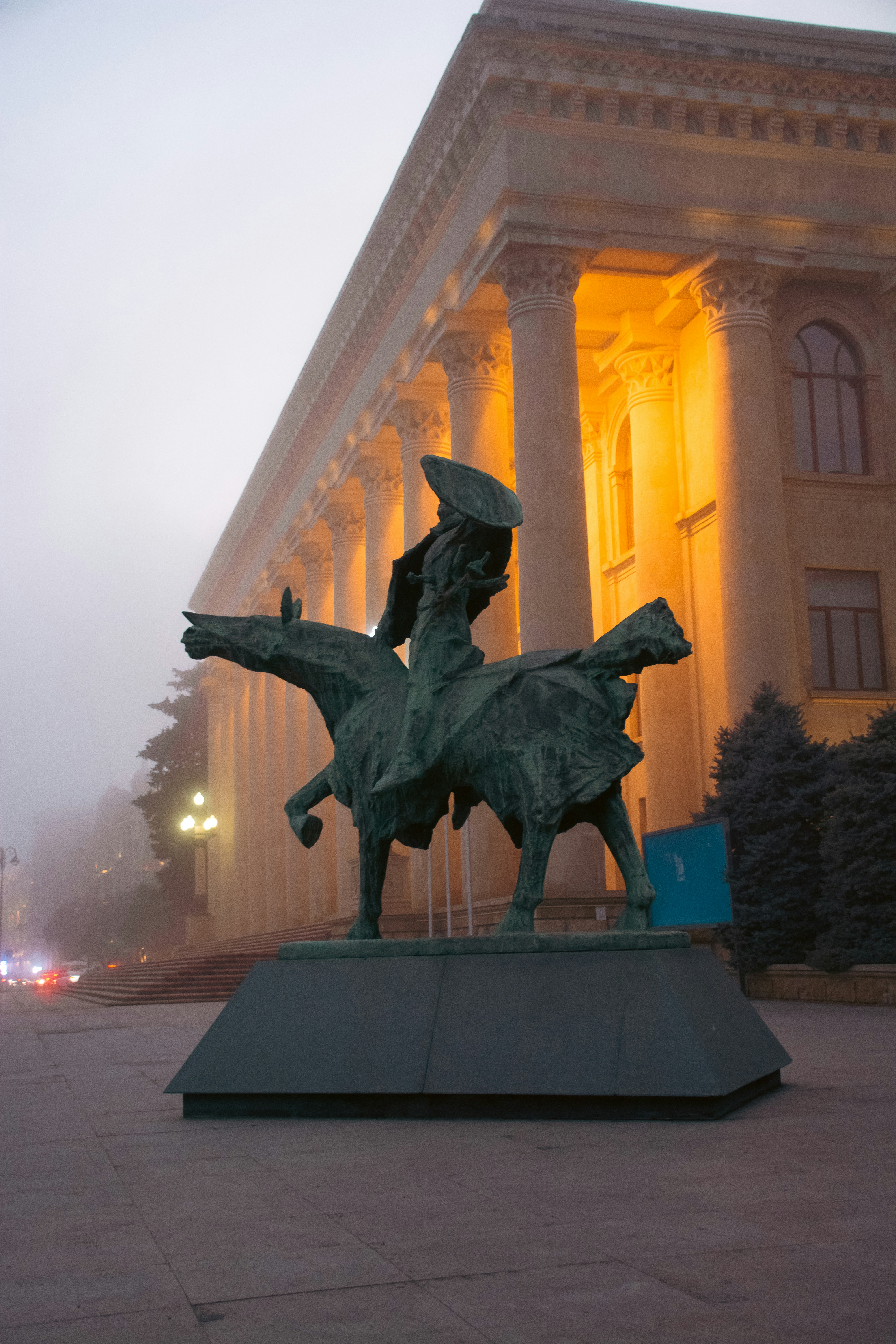Equestrian statue in front of a grand building