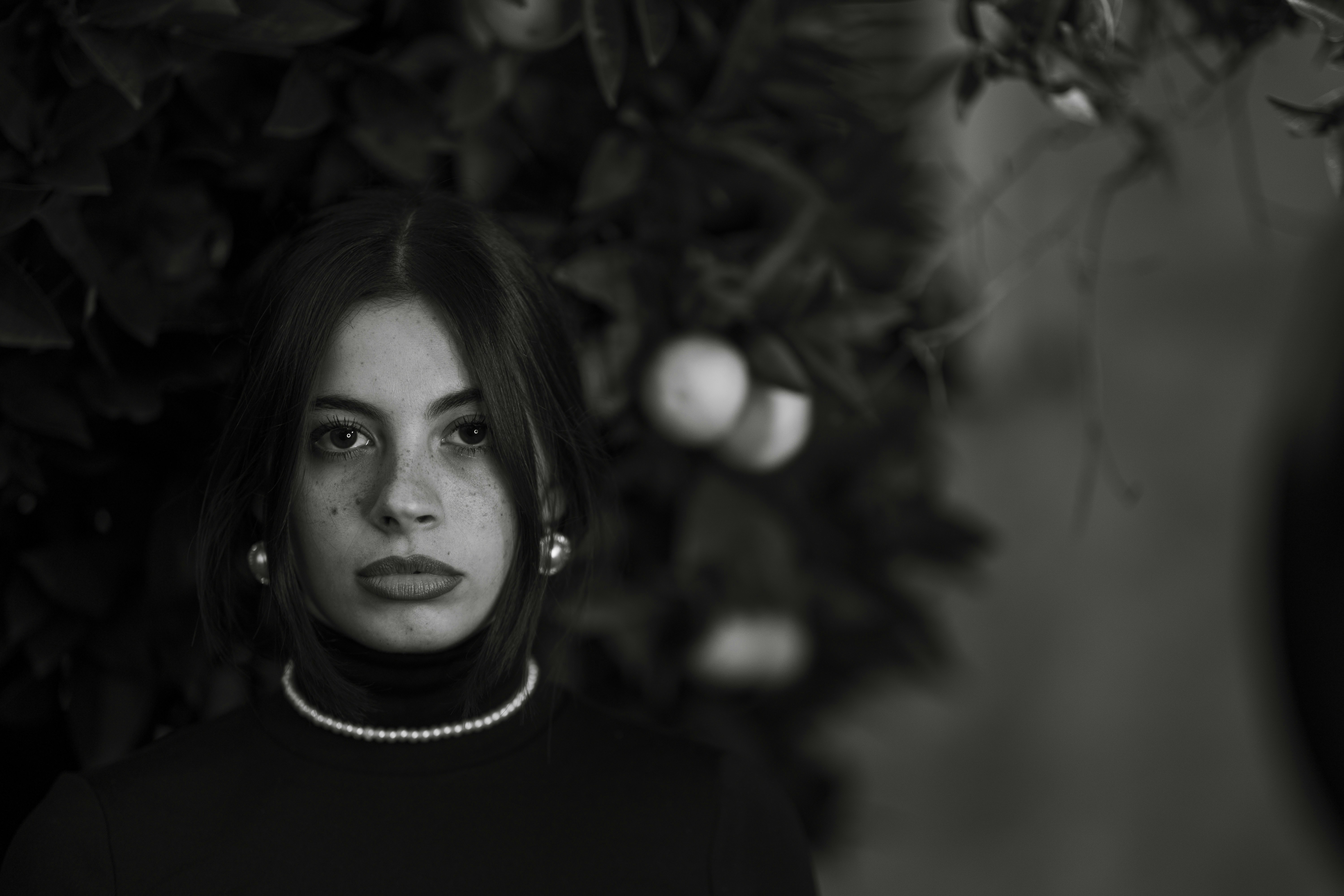 Young woman in turtleneck with pearl necklace