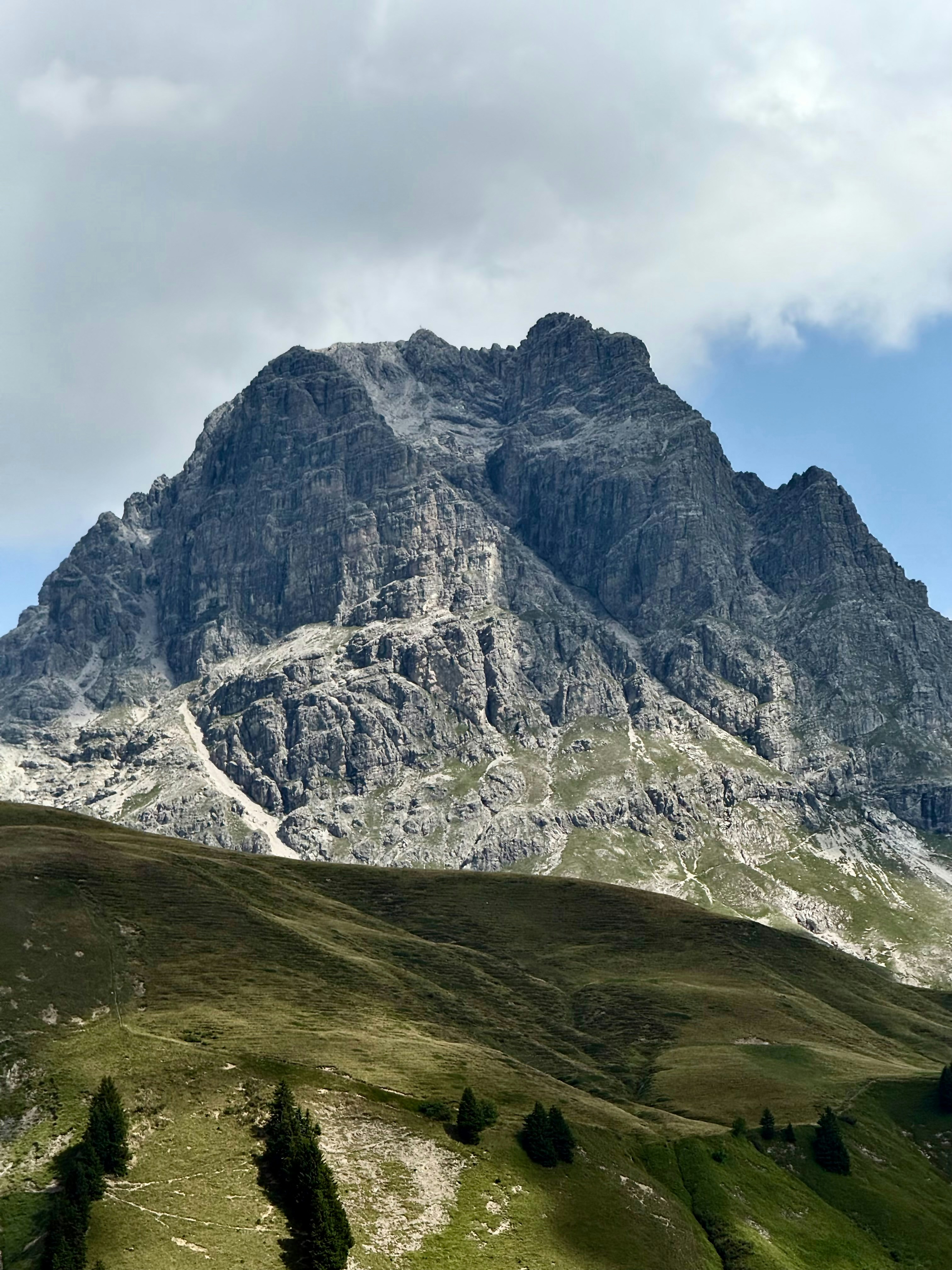 Jagged rocky mountain peak under a cloudy sky