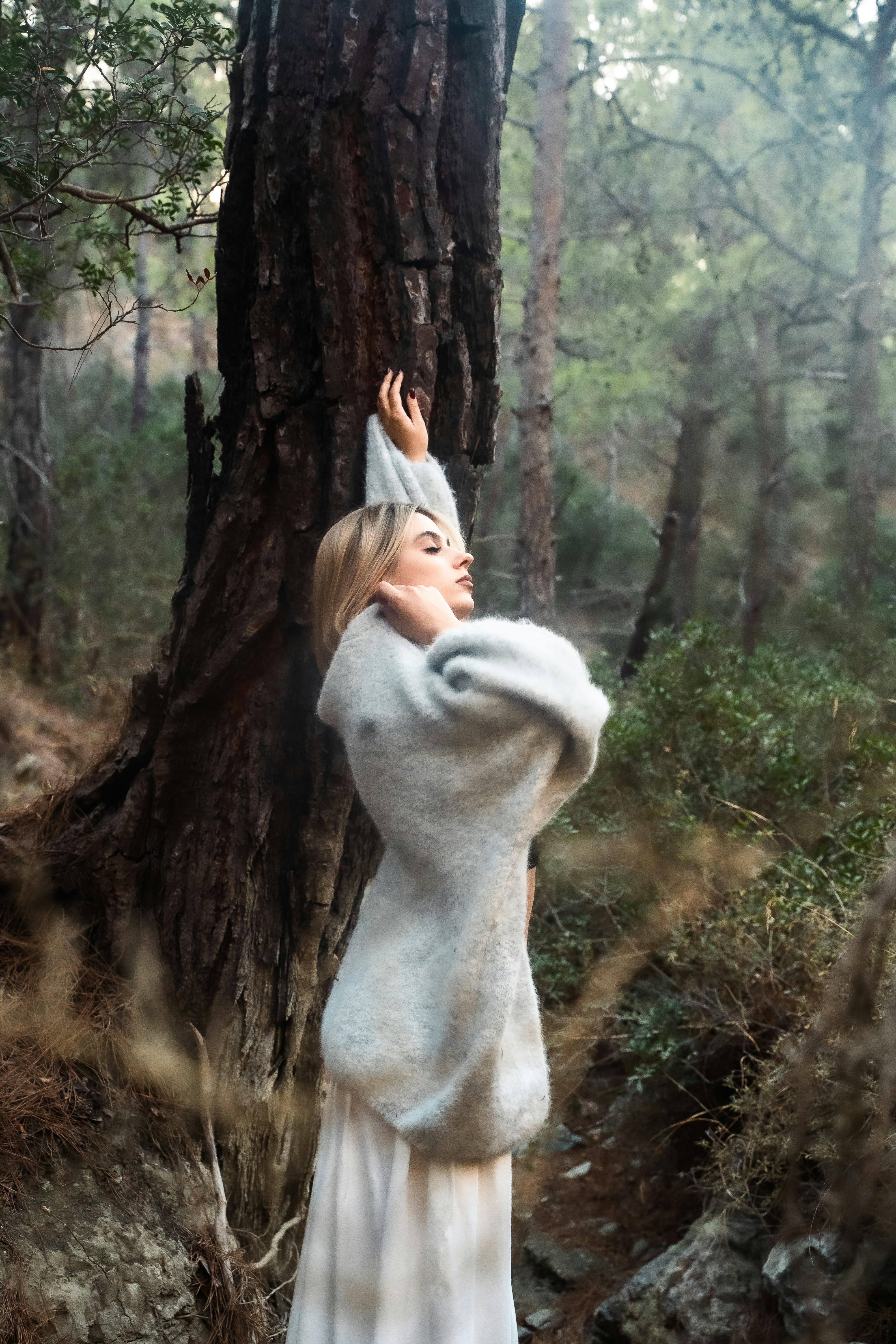 Woman in a sweater standing in a forest photo – Free Forest Image on ...