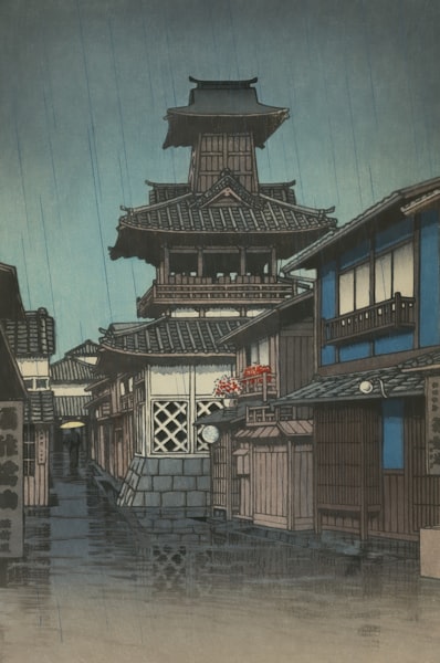 Traditional Japanese buildings along a street on a rainy day